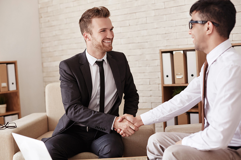 Business partners handshaking in office before meeting